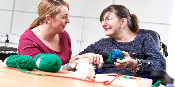 Resident and carer sewing