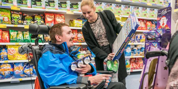 Resident from Symonds House with her carer in the supermarket