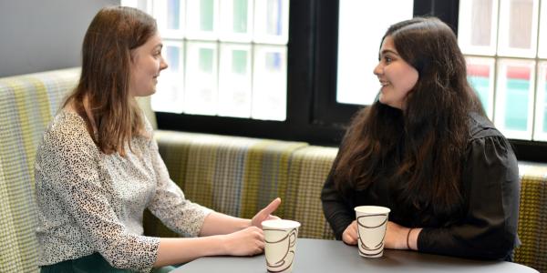 Two Change 100 interns chatting over coffee during their internship at Overbury