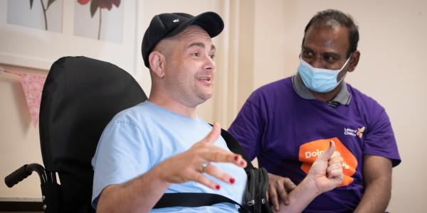 Neal, resident, with a member of staff at Llanhennock Lodge