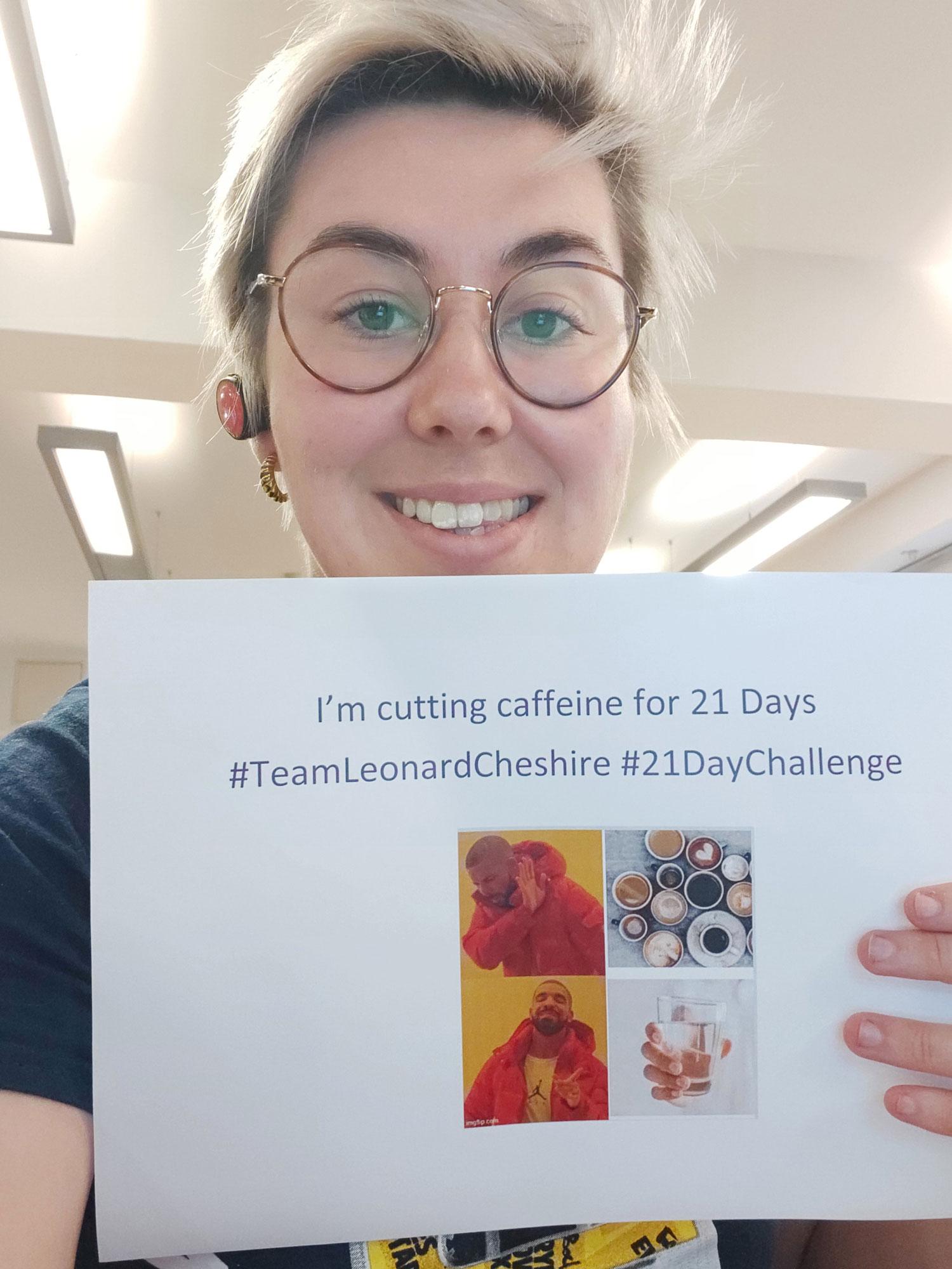 Stephanie Boulter holding a sign that says "I'm cutting caffeine for 21 days #TeamLeonardCheshire #21DayChallenge"