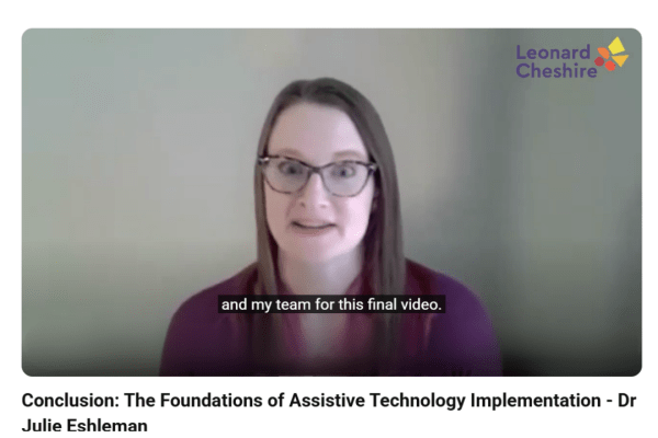 A dark haired Caucasian woman with glasses on screen and still captions