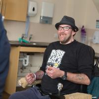 Resident in kitchen at Ty Cwm