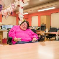 A woman in a wheelchair looking off camera