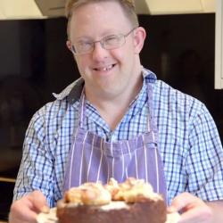 Paul, a resident at Bell's Piece, holding his Spice Apple Cinnamon cake