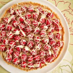 BerryWorld's raspberry and white chocolate tart presented on a white plate