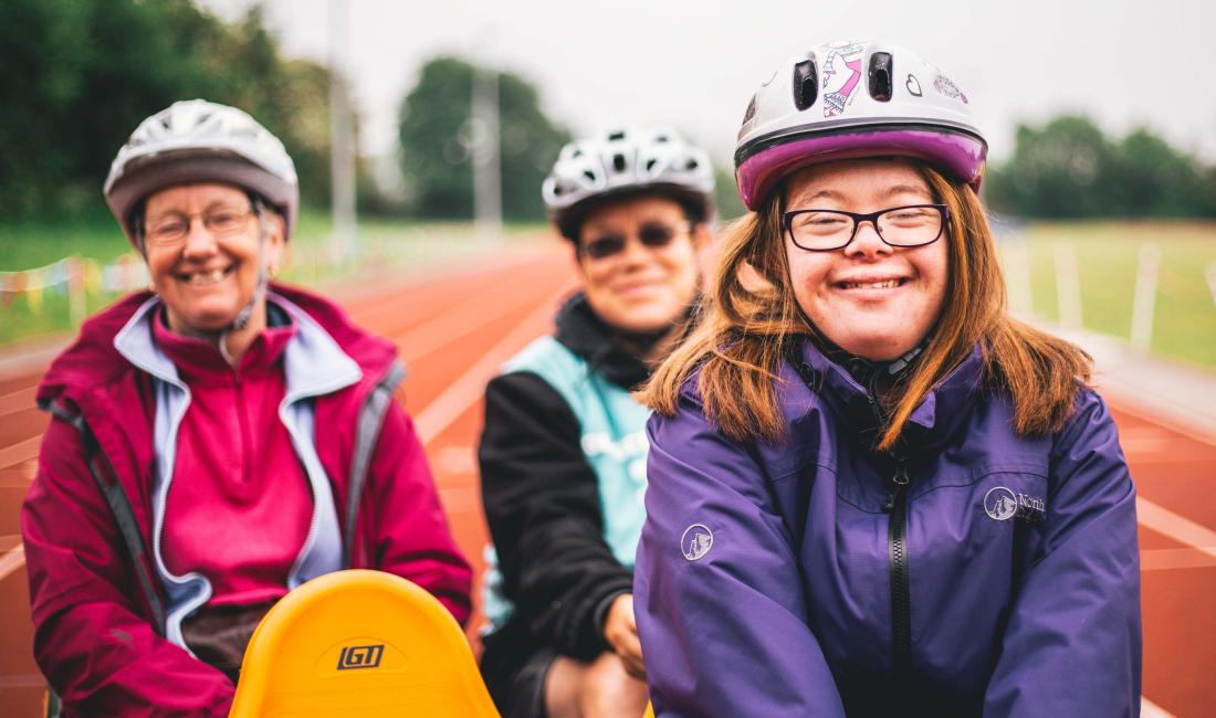 Helen on an adapted bike with two older women behind her