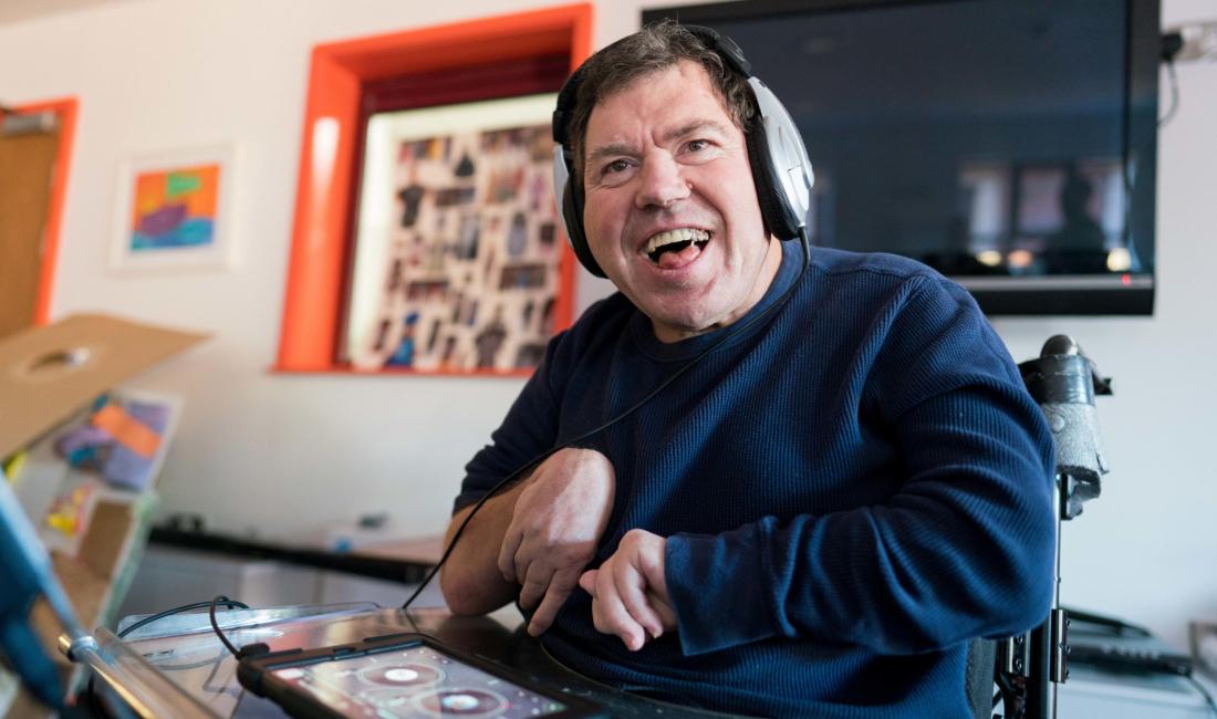 Man using headphones and an ipad
